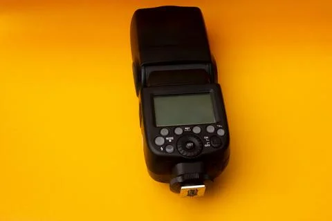 Camera flash on yellow background Stock Photos
