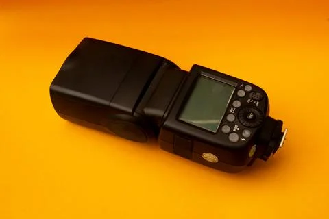 Camera flash on yellow background Stock Photos