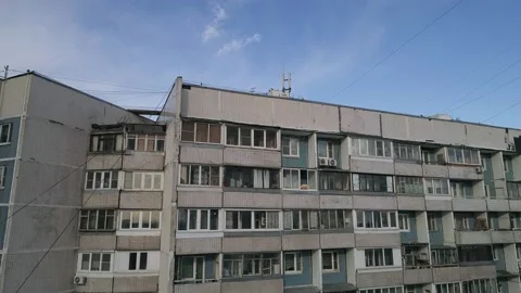 The camera flies around a concrete high-rise building Stock Footage 146955408