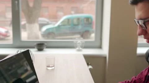 Camera flies around developer writing program code on computer display alone in Stock Footage 220251153