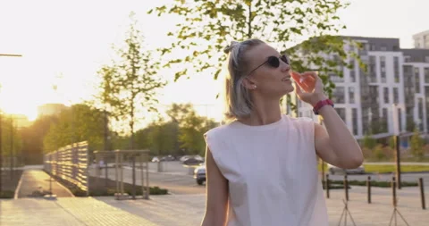 Camera Flies Around Pretty Blonde. Girl Standing on Street. Tourist. Vacation Stock Footage 136737600