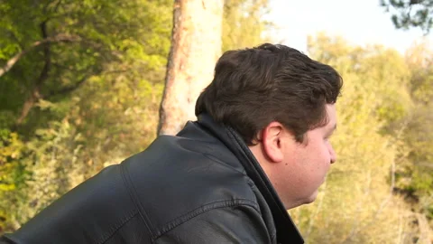 The camera flies around a young man in the park Stock Footage 87787784