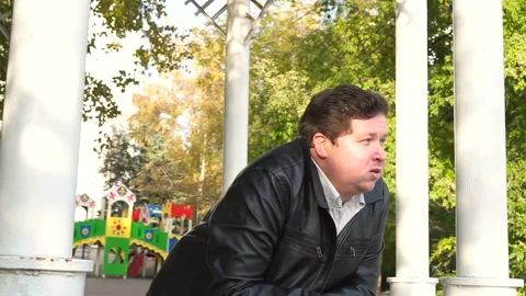 The camera flies around a young man in the park Stock Footage 87787991