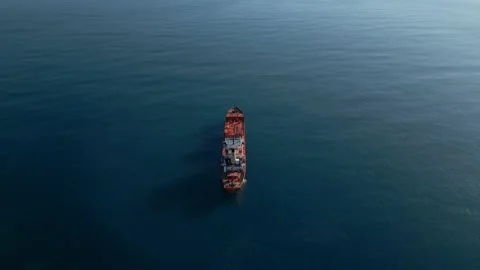 The camera flies up behind a red chemical tanker and the camera leans down Stock Footage 229320937
