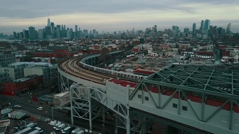 Camera flies behind a subway train headed for the Manhattan skyline Stock Footage 71328678