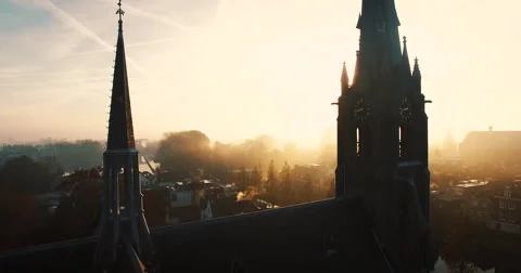 The Camera flies between two towers of a church on a foggy morning Video stock 63616583