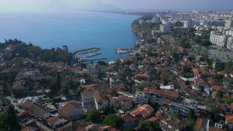The camera flies in a circle over the red roofs of the old town of Antalya Stock Footage 229579622