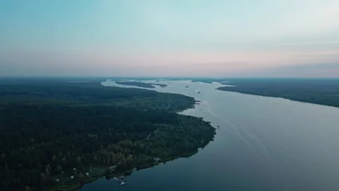The camera flies high over an incredibly large winding river towards sunset. Stock Footage 252133721