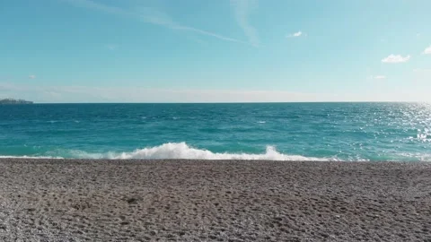 The camera flies low over the beach towards the sea and flies into the open sea Stock Footage 225685219