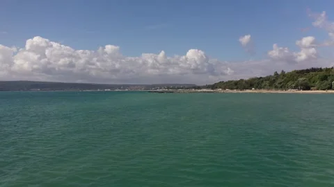 The camera flies low over the Black Sea towards the pier, along the coast. Stock Footage 137097415