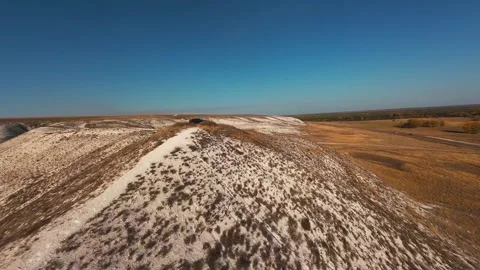 The camera flies low over the chalk mountains Stock Footage 288195230