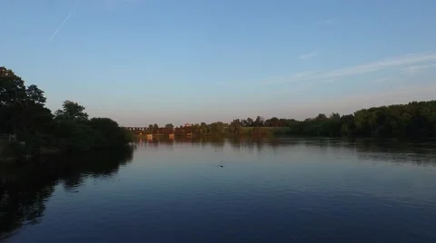 Camera flies low over the river at sunset on a Canadian summer night. 動画素材 52303784