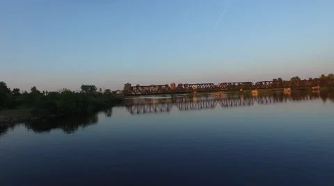 Camera flies low over the river at sunset on a Canadian summer night. 動画素材 52303789