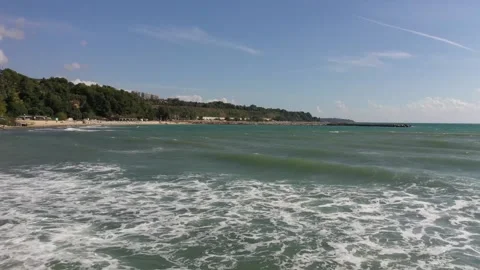 The camera flies low over the sea. Big waves in the Black Sea rush to the shore. Stock Footage 137096693