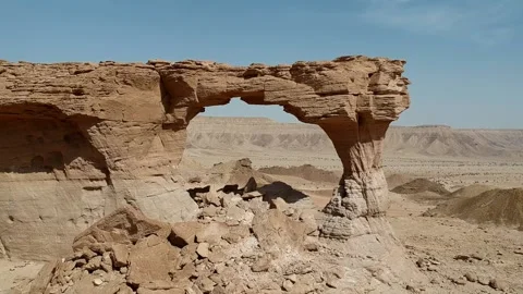 The camera flies out of The Natural Arch of Riyadh Stock Footage 153038203