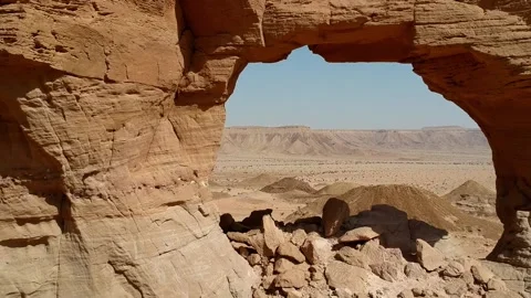 The camera flies out through The Natural Arch of Riyadh Stock Footage 153038216