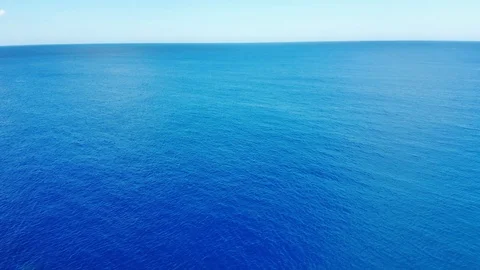 Camera flies over the blur ocean waves to the clean horizon with clouds Stock Footage 101487445