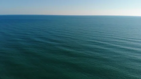 Camera flies over the blur ocean waves to the clean horizon. The camera flies Stock Footage 109134659