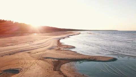 The camera flies over the coastline at sunset Stock Footage 146700568