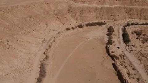Camera flies over the dried bed of Naquibs Pond in Wadi Hanifa near Riyadh Stock Footage 150252346