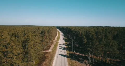 The camera flies over an empty road on a sunny day Stock Footage 146700963