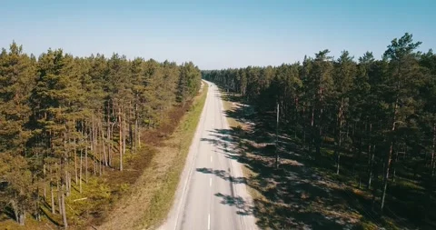 The camera flies over an empty road on a sunny day Stock Footage 146700985