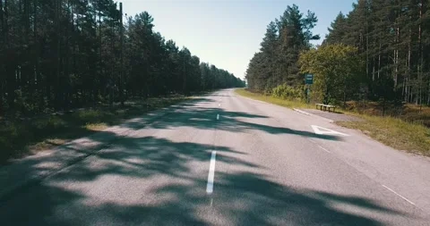 The camera flies over an empty road on a sunny day Stock Footage 146701020