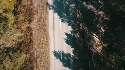 The camera flies over an empty road on a sunny day Stock Footage 146701036