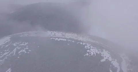 The camera flies over the lake and snow-covered forest in the fog, aerial Stock Footage 83582726