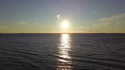 The camera flies over the lake. Sunset over the lake. Stock Footage 130588986
