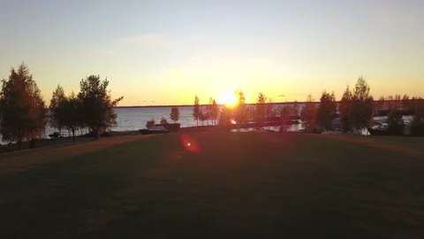 The camera flies over the lake. Sunset over the lake. Stock Footage 130589079