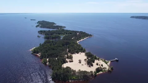 The camera flies over a large island covered with forest with sandy shores 스톡 동영상 197337519
