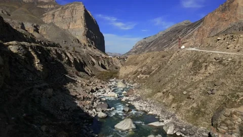 The camera flies over a mountain river in a mountainous area Stock Footage 171295359