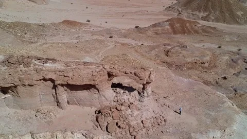 The camera flies over The Natural Arch of Riyadh Stock Footage 153038664