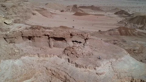 The camera flies over The Natural Arch of Riyadh Stock Footage 153038763