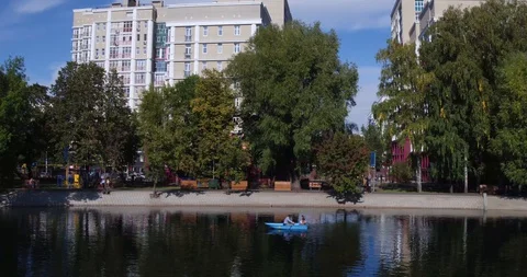 The camera flies over the pond in the city Park in the summer Stock Footage 129309766