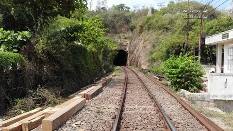 The camera flies over the railway and flies up to the railway tunnel in Vietnam Video stock 100188056