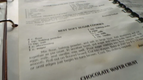 Camera flies over recipes and slides to stop at Chocolate Chip Cookies recipe Video stock 129294663