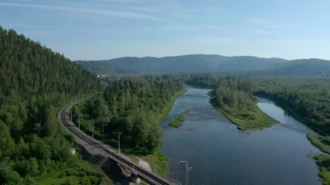 Camera flies over the river and trees. 스톡 동영상 111277849