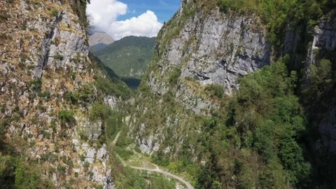 Camera flies over the road in a mountain gorge, Caucasus Mountains, Abkhazia Stock Footage 151152864
