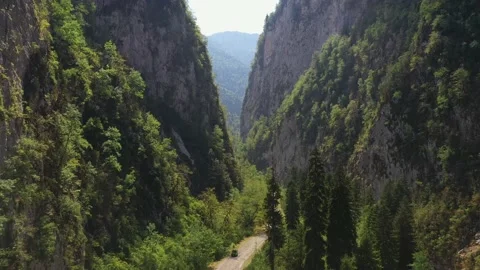 Camera flies over the road in a mountain gorge, Caucasus Mountains, Abkhazia Stock Footage 152513523