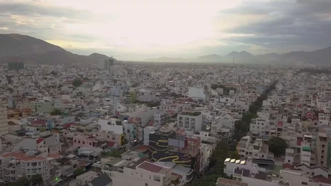 Camera flies over the roofs of Nha Trang overlooking the road Stock Footage 119015380