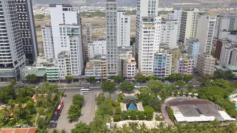 Camera flies over the roofs of Nha Trang overlooking the road Stock Footage 119018515