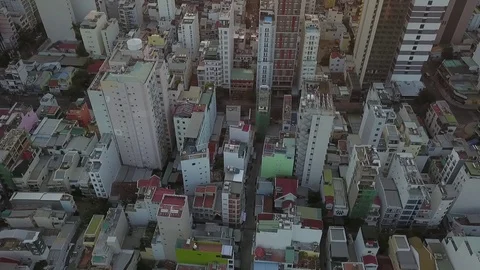 Camera flies over the roofs of Nha Trang overlooking the road sunrise Stock Footage 119107340