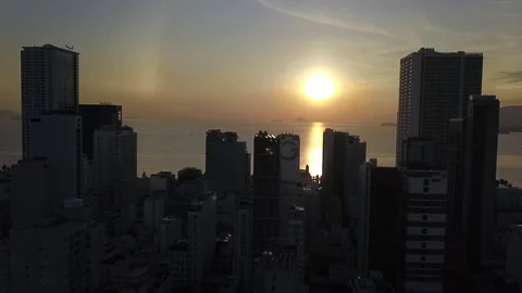 Camera flies over the roofs of Nha Trang overlooking the road sunrise Stock Footage 119116888