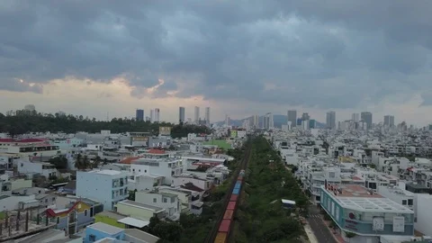Camera flies over the roofs of Nha Trang overlooking the train Video stock 119551487