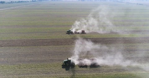 The camera flies over two tractors working in the field, side view Video stock 126587281