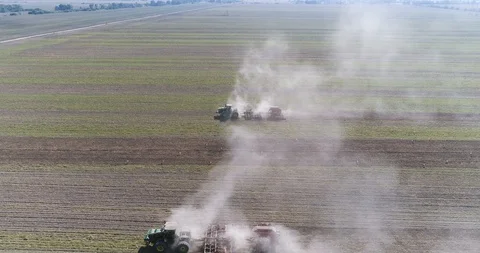 The camera flies over two tractors working in the field, aerial view Stock Footage 129039651