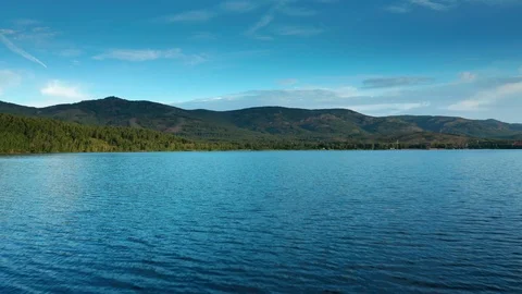 The camera flies over the water in the lake. 스톡 동영상 111661950