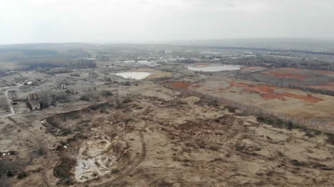 The camera flies over the work area. Yellow sands and orange polluted lakes. Stock Footage 106302646